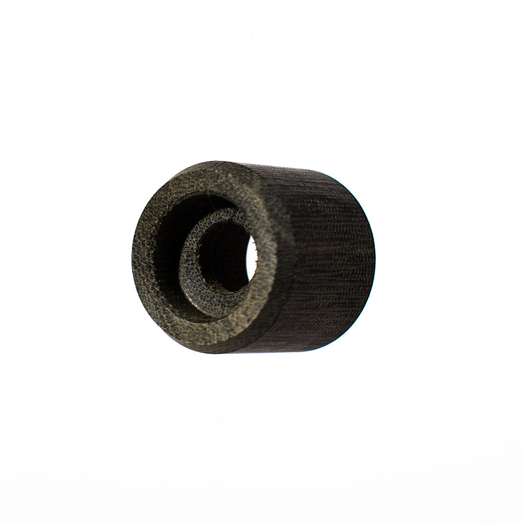 A small cylindrical black textured component with a hollow center, isolated on a plain white background.