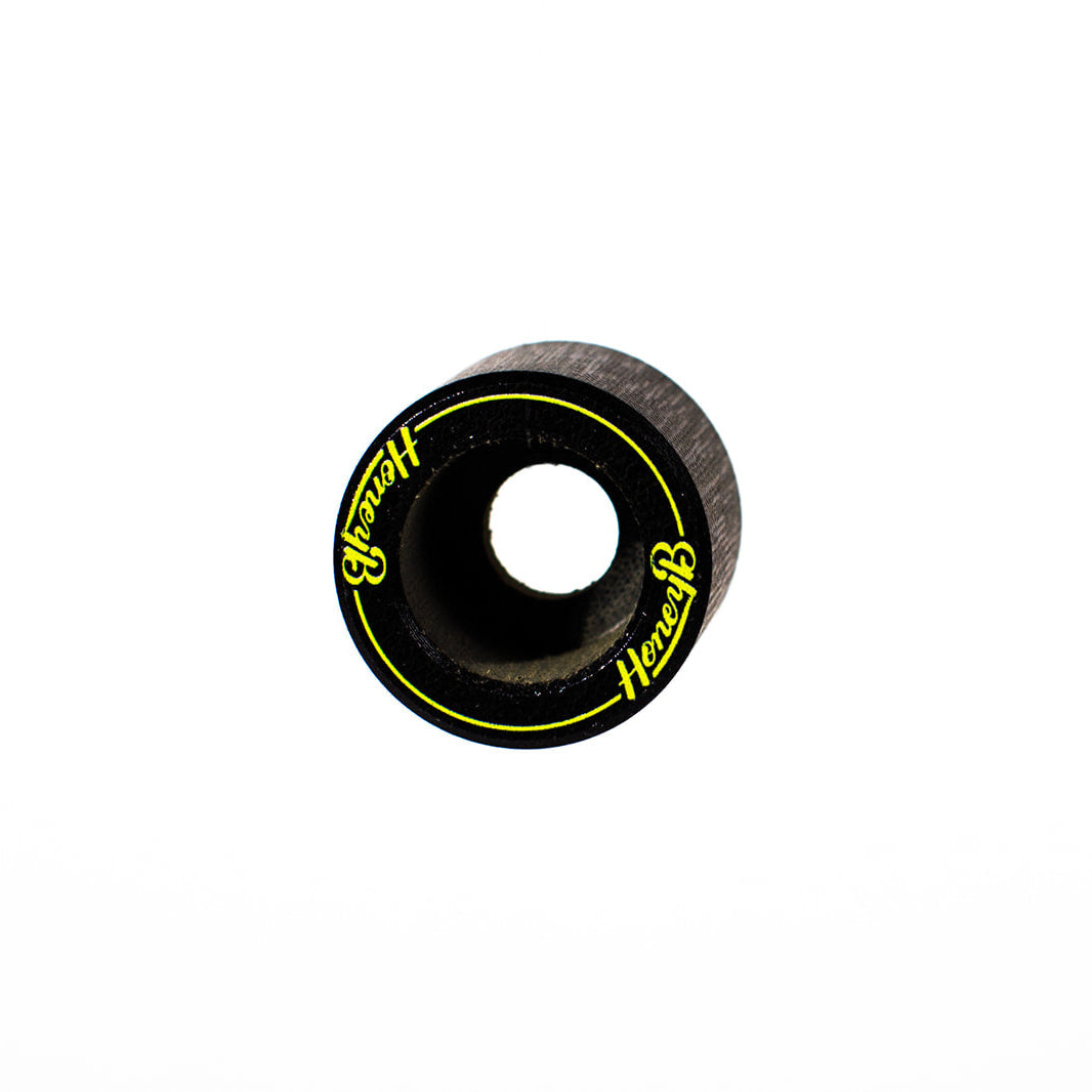 A single black skateboard wheel with a center hole, featuring yellow 'Hercules' branding and a thin yellow ring line, shown on a plain white background.