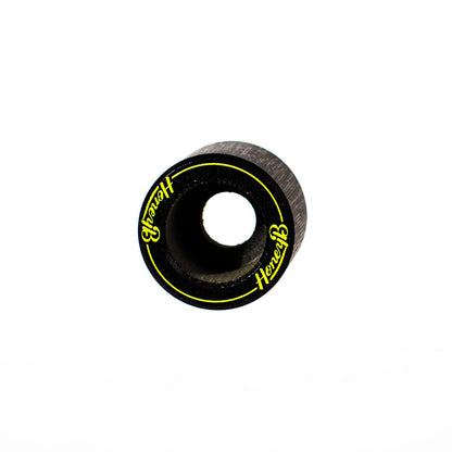 A single black skateboard wheel with a center hole, featuring yellow 'Hercules' branding and a thin yellow ring line, shown on a plain white background.