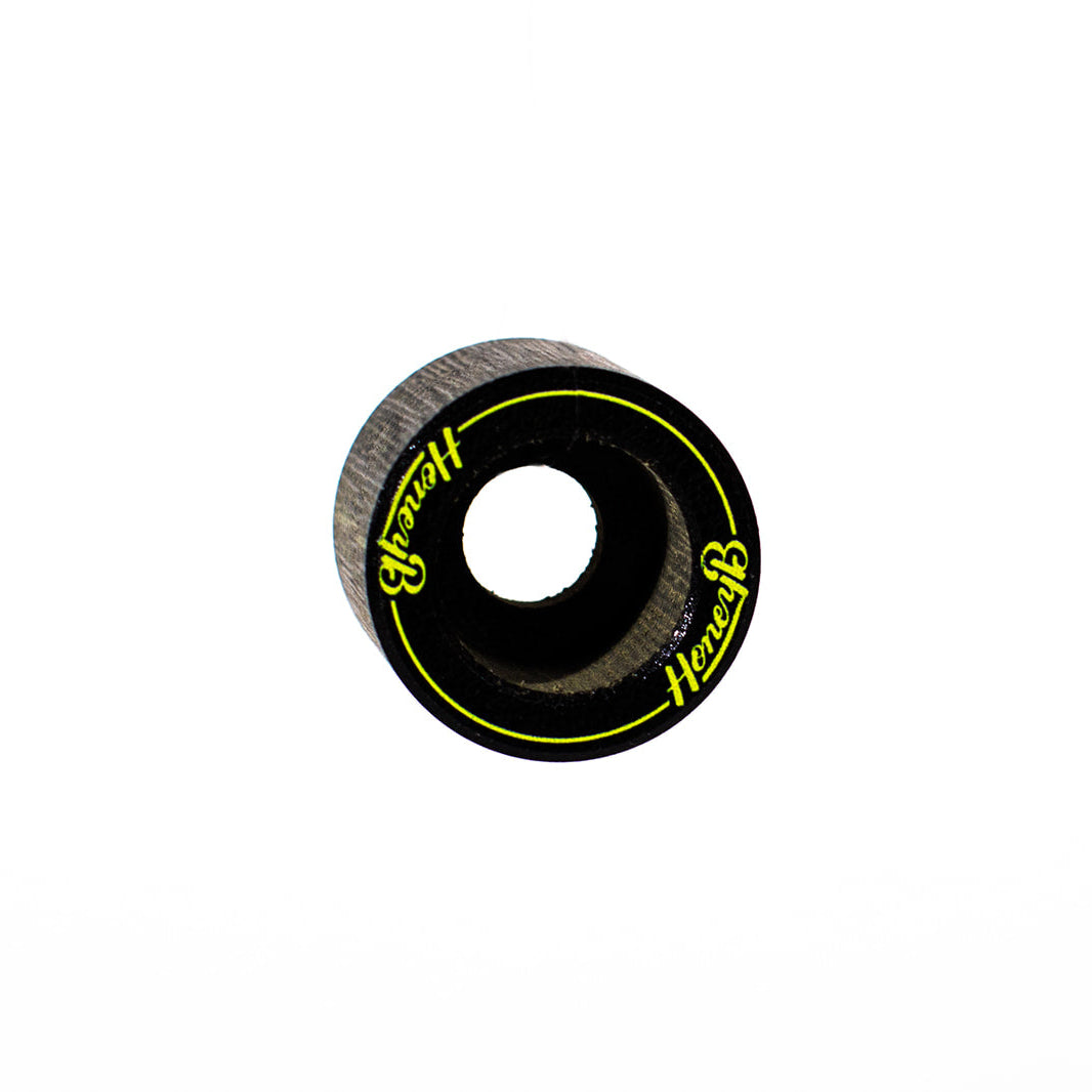 A single skateboard wheel with a black outer ring, textured gray inner barrel, and bright yellow 'Herbert' branding printed on the side, set against a plain white background.